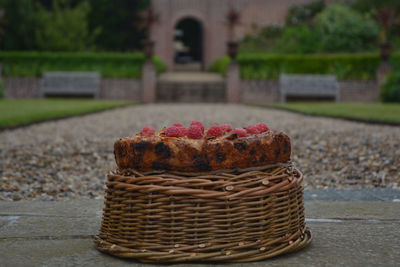 Close-up of cake on wicker basket at park