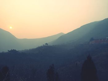 Scenic view of silhouette mountains against sky during sunset