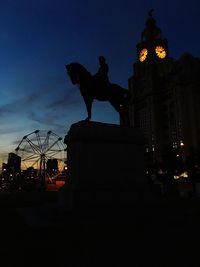 Low angle view of statue against sky at dusk