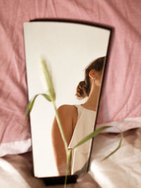 Woman relaxing on bed at home