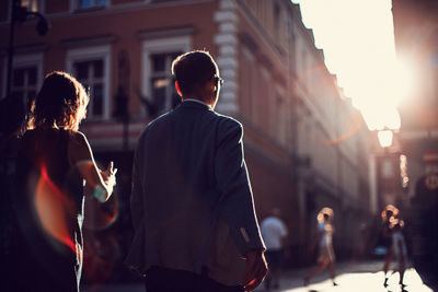 Rear view of people walking in city