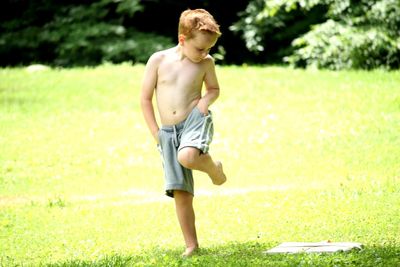 Boy standing on grass