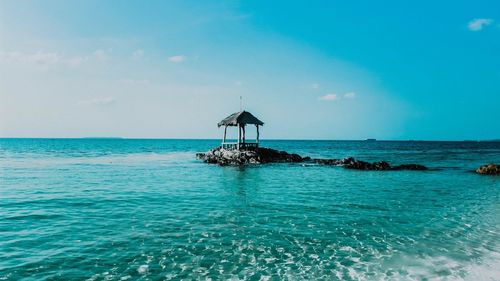 Scenic view of sea against blue sky