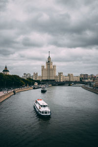 View of buildings in city against cloudy sky