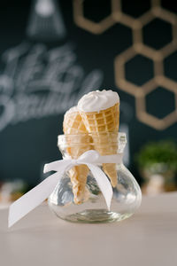 Ice cream in a waffle cup is in a glass vase. summer sweet dessert