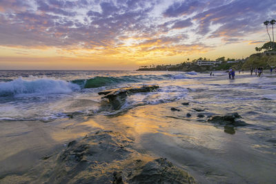 Scenic view of beach against sky during sunset