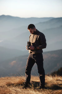 Full length of man photographing at camera