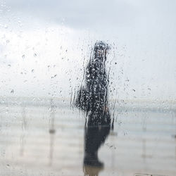 Reflection of man on glass window