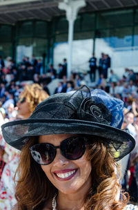 Portrait of a smiling young woman wearing sunglasses