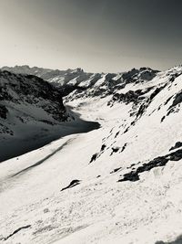 Scenic view of snow covered mountains against sky