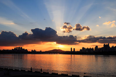 Scenic view of silhouette buildings against sky during sunset