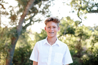 Outside portrait of a handsome teenage boy with braces