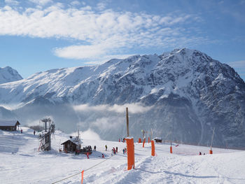 Panoramic view of ski lift against snowcapped mountains