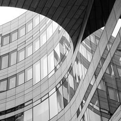 Low angle view of modern glass building in city