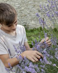 A guy with positive emotions rejoices in purple lavender flowers