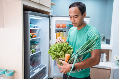 Man holding ice cream at home