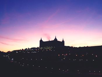 Built structures against sky at dusk