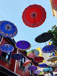Low angle view of lanterns hanging against sky