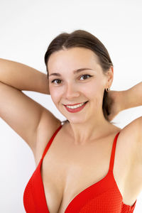 Portrait of young woman against white background