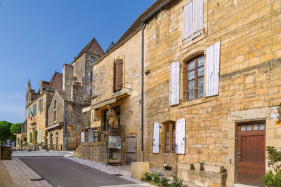 Street with historical houses in domme commune in the dordogne department, france