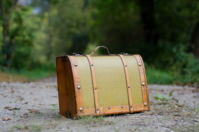 Close-up of suitcase on road