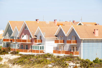 Houses in city against clear sky