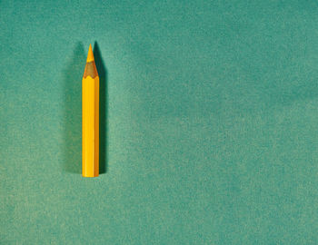 Directly above shot of yellow colored pencil on table