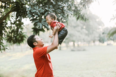 Father and son standing on tree