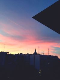 Silhouette of buildings against dramatic sky