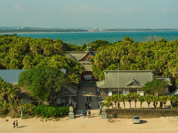 High angle view of beach and buildings against sky shrines