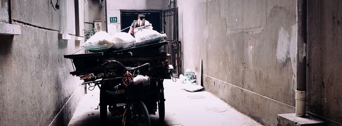 People working in alley amidst buildings in city