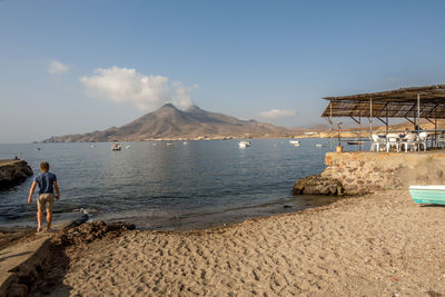 People on beach against sky