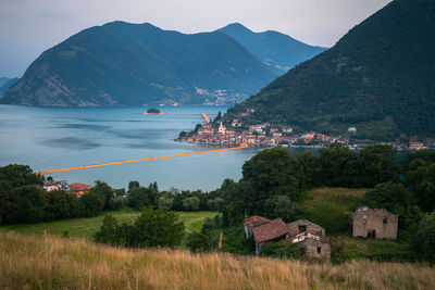 Scenic view of buildings and mountains against sky