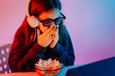 Girl watching movie on laptop at home
