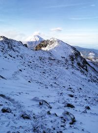 Scenic view of snow covered mountains against sky