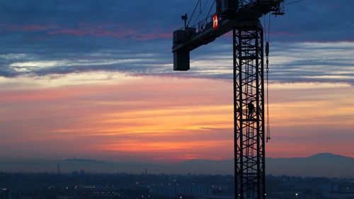 Crane against sky during sunset