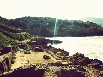 Scenic view of waterfall against sky