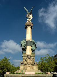 Low angle view of statue against sky