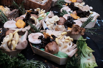 High angle view of edible mushrooms in containers on table