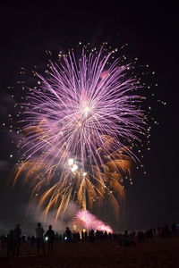 Low angle view of firework display at night