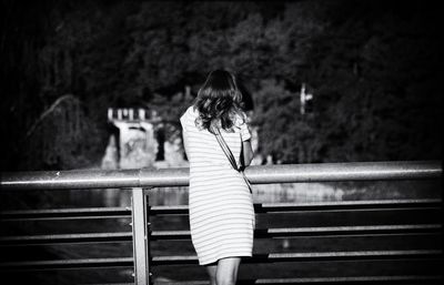 Rear view of woman sitting on staircase