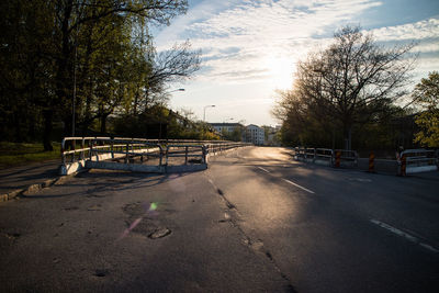 Road by trees against sky