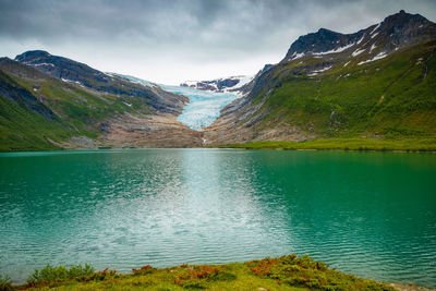 Scenic view of lake and mountains against sky