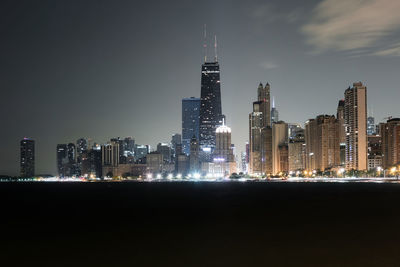 View of skyscrapers lit up at night