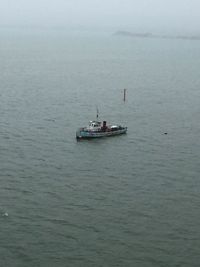 Boat sailing in sea against sky