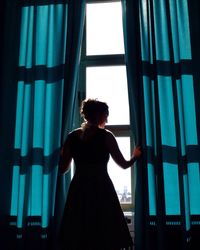 Woman looking through window