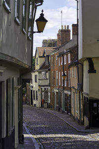 Narrow street amidst buildings in city