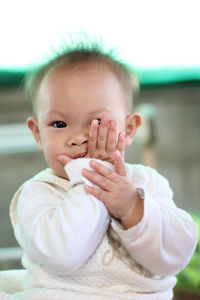 Portrait of cute baby girl sitting at home