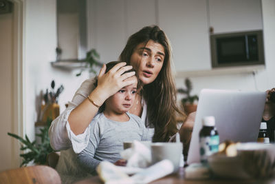 Woman using mobile phone at home