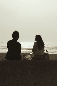 View of people sitting on beach